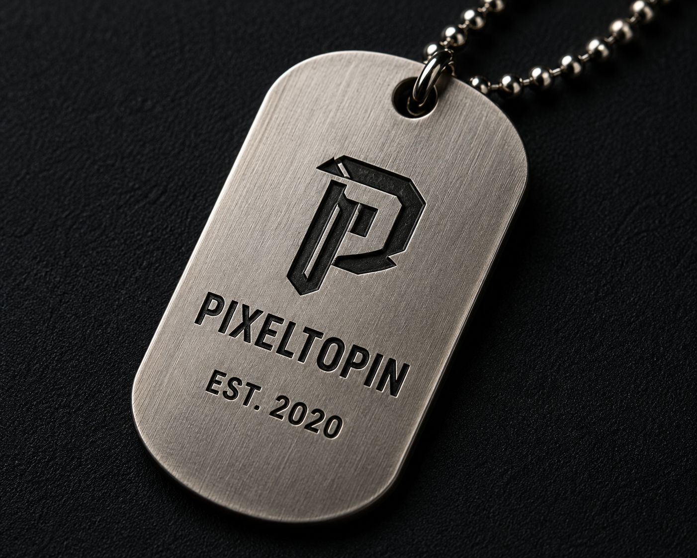 Custom brushed silver metal tag with engraved logo and lettering