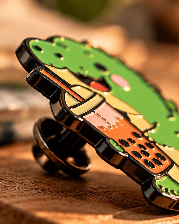 Side view of a soft enamel pin showing raised metal edges and recessed enamel areas